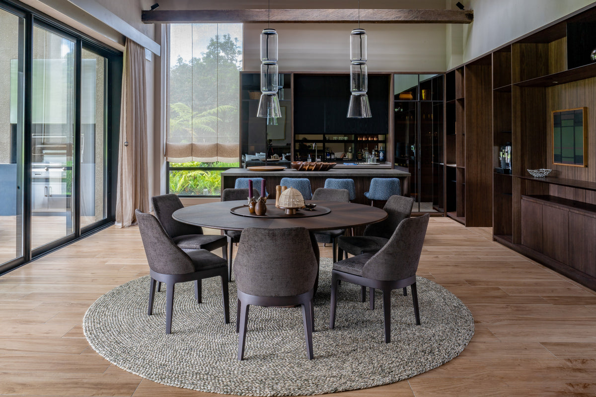 Handwoven VERDI rug anchoring a living space, natural fiber interwoven with metal thread